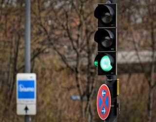 What should you do if you encounter a faulty traffic signal?
