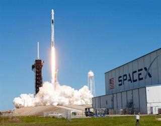 SpaceX capsule ferries NASA crew and Russian astronauts as it heads to space station